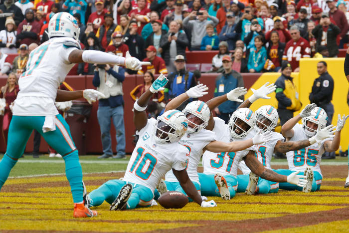 Miami Dolphins wide receiver Tyreek Hill (10) celebrates in the end zone after catching a touchdown pass against the Washington Commanders during the first quarter at FedExField.